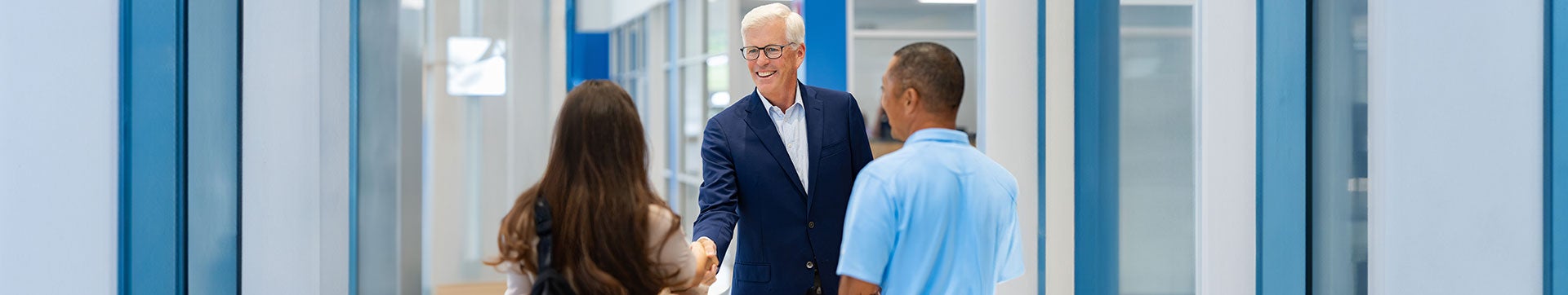 Man shaking hands with a couple